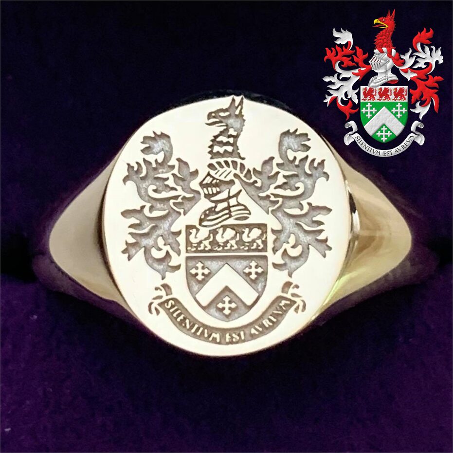 Vert, a chevron, between three cross-crosslets; on a chief Argent, three griffins statant Gules, beaked and armed Or. Crest: Upon a helm, with a wreath Argent and Gules, a griffin's head couped Gules, beaked Or. Mantling: Gules doubled Argent. Motto: Silentium est aureum.