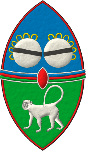 Escudo cortado, perfilado de gules: 1o de azur, dos tambores reales en faja de plata, cordados de oro, cargados cada uno con una burela de sable; 2o de sinople, un mono parado de plata; brochante sobre la partici�n una faja terciada en faja de azur, gules y sinople, perfilada de plata; brochante sobre el todo un escus�n de gules, perfilado de plata.