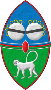 Escudo cortado, perfilado de gules: 1o de azur, dos tambores reales en faja de plata, cordados de oro, cargados cada uno con una burela de sable; 2o de sinople, un mono parado de plata; brochante sobre la partici�n una faja terciada en faja de azur, gules y sinople, perfilada de plata; brochante sobre el todo un escus�n de gules, perfilado de plata.