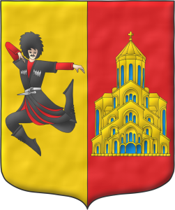 Escudo partido: 1o de oro, un bailarn georgiano al natural; 2o de gules, una iglesia de oro, aclarada de azur.