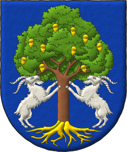 Escudo de azur, una encina al natural, frutada y arrancada de oro, con dos cabras de plata empinadas al tronco.