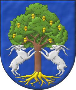 Escudo de azur, una encina al natural, frutada y arrancada de oro, con dos cabras de plata empinadas al tronco.
